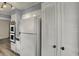 Clean kitchen with white appliances, cabinetry, and access to extra storage at 2330 Harlan St, Indianapolis, IN 46203
