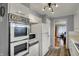 Cozy kitchen featuring a vintage double oven, white cabinets, and wood-look vinyl flooring at 2330 Harlan St, Indianapolis, IN 46203