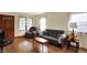 Comfortable living room with hardwood floors, a cozy chair, and natural light from the windows at 2330 Harlan St, Indianapolis, IN 46203
