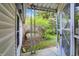 Covered porch overlooking a green yard and mature trees at 2330 Harlan St, Indianapolis, IN 46203