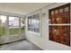 Cozy screened porch with access to the front door and views of the front yard at 2330 Harlan St, Indianapolis, IN 46203