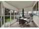 Sunroom with seating, a table and umbrella overlooking the backyard at 2330 Harlan St, Indianapolis, IN 46203