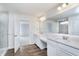Elegant bathroom boasting dual vanities, a glass shower, and wood look flooring at 2741 Penn Ave, Plainfield, IN 46168