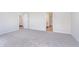 Spacious carpeted bedroom with dual doorways leading to bathrooms at 2741 Penn Ave, Plainfield, IN 46168