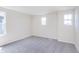 Well-lit carpeted bedroom features multiple windows, enhancing the bright space at 2741 Penn Ave, Plainfield, IN 46168