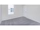 Cozy bedroom with a gray carpet, white walls, and window at 2741 Penn Ave, Plainfield, IN 46168