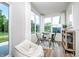 Bright breakfast nook features large windows, a round table with seating, and stylish decor at 2741 Penn Ave, Plainfield, IN 46168