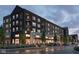Modern mixed-use building with retail spaces, balconies, and stylish brick facade, creating an inviting urban atmosphere at 2741 Penn Ave, Plainfield, IN 46168