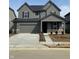 Two-story home featuring a two-car garage, dark shutters, and stone accents at 2741 Penn Ave, Plainfield, IN 46168