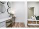 Stylish hallway nook featuring a desk, woven chair, and elegant decorative mirrors at 2741 Penn Ave, Plainfield, IN 46168