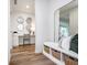 Inviting hallway featuring a bench with storage, decorative mirrors, and wood-look flooring at 2741 Penn Ave, Plainfield, IN 46168