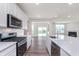 Modern kitchen with stainless steel appliances, center island with seating, and white cabinetry at 2741 Penn Ave, Plainfield, IN 46168