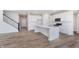 Modern kitchen with white cabinets, a center island, stainless steel appliances, and hardwood floors at 2741 Penn Ave, Plainfield, IN 46168