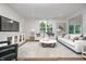 Bright living room featuring modern decor, light-colored furniture, large windows, and vinyl wood-look flooring at 2741 Penn Ave, Plainfield, IN 46168