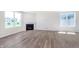 Spacious living room with a cozy fireplace and plenty of natural light from large windows at 2741 Penn Ave, Plainfield, IN 46168