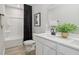Modern bathroom featuring a shower with tub, vanity with a large mirror, and contemporary fixtures, and wood look tile flooring at 2759 Evergreen Ave, Plainfield, IN 46168