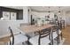 Dining area featuring a wooden table, upholstered chairs, and modern decor at 2759 Evergreen Ave, Plainfield, IN 46168