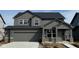 Two-story home featuring a gray exterior, a two-car garage, and a covered front porch at 2759 Evergreen Ave, Plainfield, IN 46168