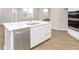 Close up of a large white kitchen island with stainless steel dishwasher and double sink at 2759 Evergreen Ave, Plainfield, IN 46168