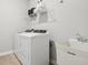 Clean laundry room featuring a washer, dryer, sink, and shelving at 2759 Evergreen Ave, Plainfield, IN 46168