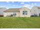 Spacious backyard featuring a well-kept lawn, patio area, and residential fence at 3627 Miesha Dr, Indianapolis, IN 46217