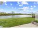 Scenic view from the backyard of a grassy lawn leading to a tranquil body of water at 3627 Miesha Dr, Indianapolis, IN 46217
