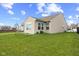 Large backyard with lush grass, patio, and partial view of neighboring homes at 3627 Miesha Dr, Indianapolis, IN 46217