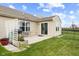 Well-maintained backyard with patio, lawn, and a garden bed with flowers at 3627 Miesha Dr, Indianapolis, IN 46217