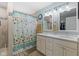 Bathroom featuring double sink vanity, walk-in shower, and beach themed decor at 3627 Miesha Dr, Indianapolis, IN 46217