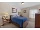 Comfortable bedroom with a dark wood frame bed, carpet flooring, and natural light at 3627 Miesha Dr, Indianapolis, IN 46217