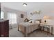 Cozy bedroom with soft carpet, wooden bed frame, and decor shelves above the bed at 3627 Miesha Dr, Indianapolis, IN 46217