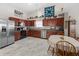 Modern kitchen with stainless steel appliances, hardwood cabinets, and an adjoining dining area at 3627 Miesha Dr, Indianapolis, IN 46217
