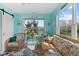 Inviting sunroom with wicker furniture, large windows, and beautiful views of the backyard at 3627 Miesha Dr, Indianapolis, IN 46217