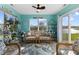 Bright sunroom with wicker furniture, a ceiling fan, and scenic views of the outdoors at 3627 Miesha Dr, Indianapolis, IN 46217