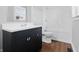 Modern bathroom features a sleek vanity, subway tile shower, and wood grain floors at 402 W 38Th St, Indianapolis, IN 46208