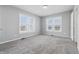 Bright bedroom with neutral carpet, light gray paint, and two windows at 402 W 38Th St, Indianapolis, IN 46208