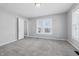 Spacious bedroom with neutral carpet, light gray paint, and ample natural light at 402 W 38Th St, Indianapolis, IN 46208