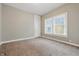 Bedroom features neutral carpet, light beige paint, and two large windows at 402 W 38Th St, Indianapolis, IN 46208