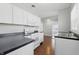 Clean, bright kitchen with white appliances and sleek black countertops at 402 W 38Th St, Indianapolis, IN 46208