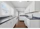 Bright kitchen with white cabinets, black countertops, and hardwood floors at 402 W 38Th St, Indianapolis, IN 46208