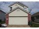 Two-car garage with vinyl siding, brick accents, and a paved driveway at 42 White Lick Dr, Indianapolis, IN 46227