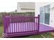 Outdoor wooden deck painted purple, accessible via a sliding glass door from the home at 42 White Lick Dr, Indianapolis, IN 46227