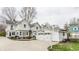 Spacious backyard with basketball hoop, garage, patio with seating, and green lawn at 4451 N Washington Blvd, Indianapolis, IN 46205