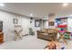 Finished basement with neutral carpet, couches, and director's chairs, with storage and decor at 4451 N Washington Blvd, Indianapolis, IN 46205
