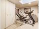 Finished basement area featuring home gym equipment and a recreational basketball game at 4451 N Washington Blvd, Indianapolis, IN 46205