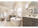 Bright bathroom features a freestanding tub, double vanities, and modern fixtures at 4451 N Washington Blvd, Indianapolis, IN 46205