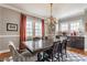Elegant dining room featuring a chandelier, dark wood table and buffet with natural light and an area rug at 4451 N Washington Blvd, Indianapolis, IN 46205