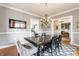 Dining room features a large table, decorative chandelier, hardwood floors and neutral paint at 4451 N Washington Blvd, Indianapolis, IN 46205