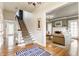 Inviting entryway with hardwood floors leading to the staircase and formal living room at 4451 N Washington Blvd, Indianapolis, IN 46205