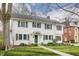 Charming two-story white home with a well-manicured lawn and traditional architectural details at 4451 N Washington Blvd, Indianapolis, IN 46205